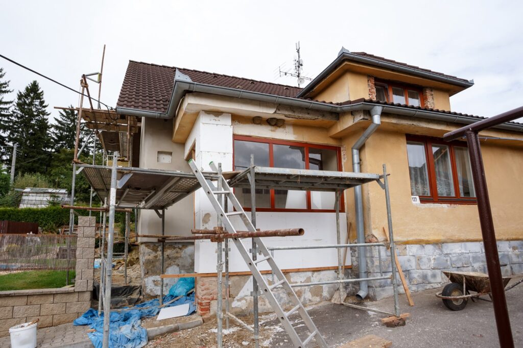 15 tips for whole home remodeling projects blog with exterior of home being remodeling
